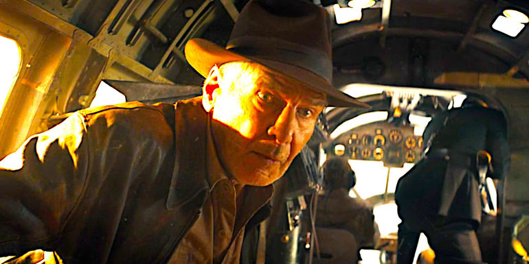 Indy (Harrison Ford) wearing a shocked expression in an old fashioned bomber aircraft in Indiana Jones and the Dial of Destiny