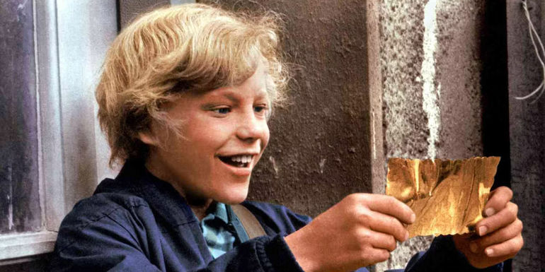 Peter Ostrum as Charlie Bucket smiling at his Golden Ticket in Willy Wonka and the Chocolate Factory