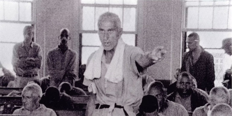 A grainy, black-and-white shot of a patient-inmate in Frederick Wiseman's 1967 documentary, Titicut Follies.
