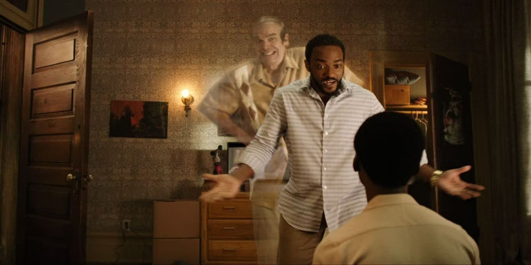 Anthony Mackie as Frank Presley with David Harbour as Ernest Behind Him in We Have a Ghost