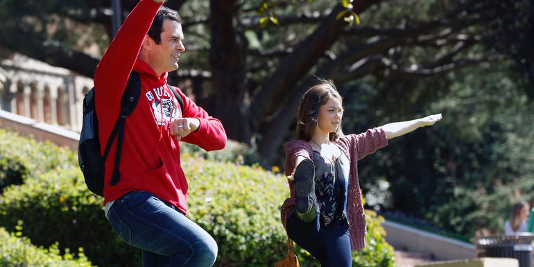 Phil and Haley practicing cheerleading in Modern Family