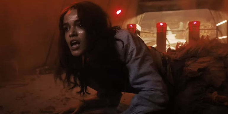 Lucy Gray is on the ground of the arena with her mouth open in The Hunger Games: The Ballad of Songbirds and Snakes.