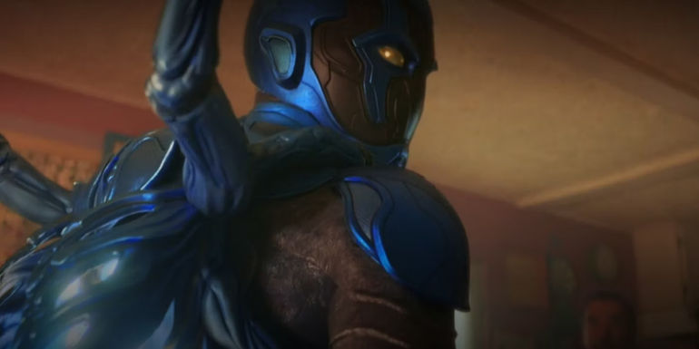 Jaime looking over his shoulder with his suit on in Blue Beetle