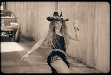 Shakira's Sizzling Sepia Serenade: A Dance with the Hat in the Limelight