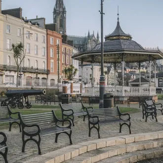 Urban public park with benches and city architecture