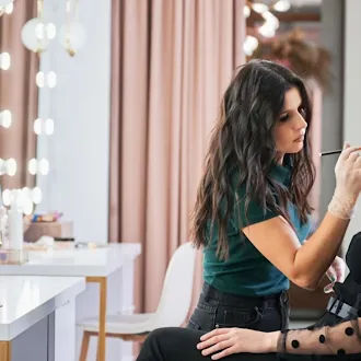 Professional makeup artist applying makeup to client