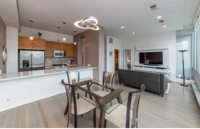 500 W Superior St Unit 1311 The Montgomery on Superior River North whole-home renovation by Assembly Squad -- kitchen refresh with 1×4 herringbone backsplash, guest bath full rebuild, primary bath shower pan, 9 JELD-WEN MODA doors, new oak flooring, 3-panel coated tempered glass transom in Chicago