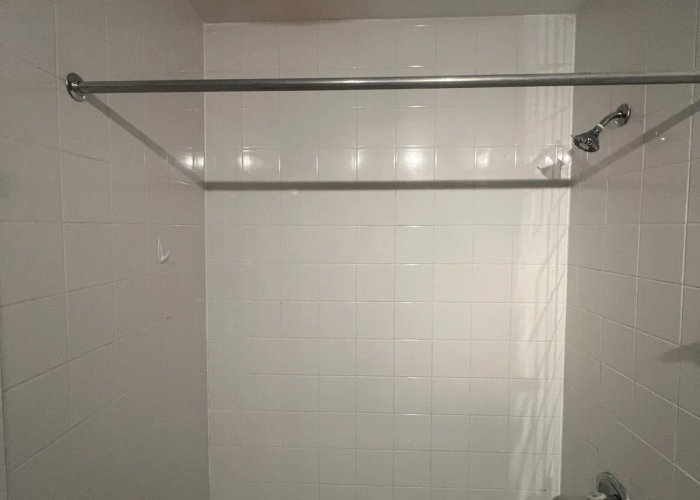680 N Lake Shore Drive Streeterville bathroom before renovation -- dark black tiles original dated condition