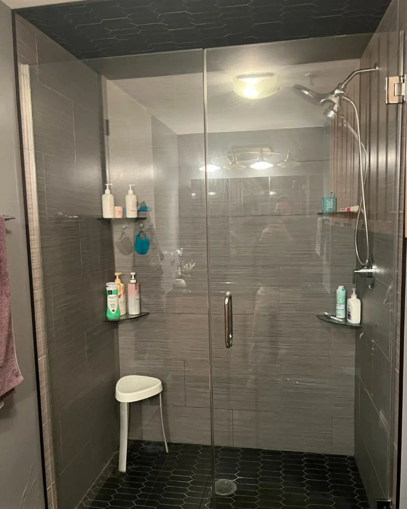 Streeterville condo bathroom after renovation -- walk-in shower conversion with glass enclosure and designer tile Chicago