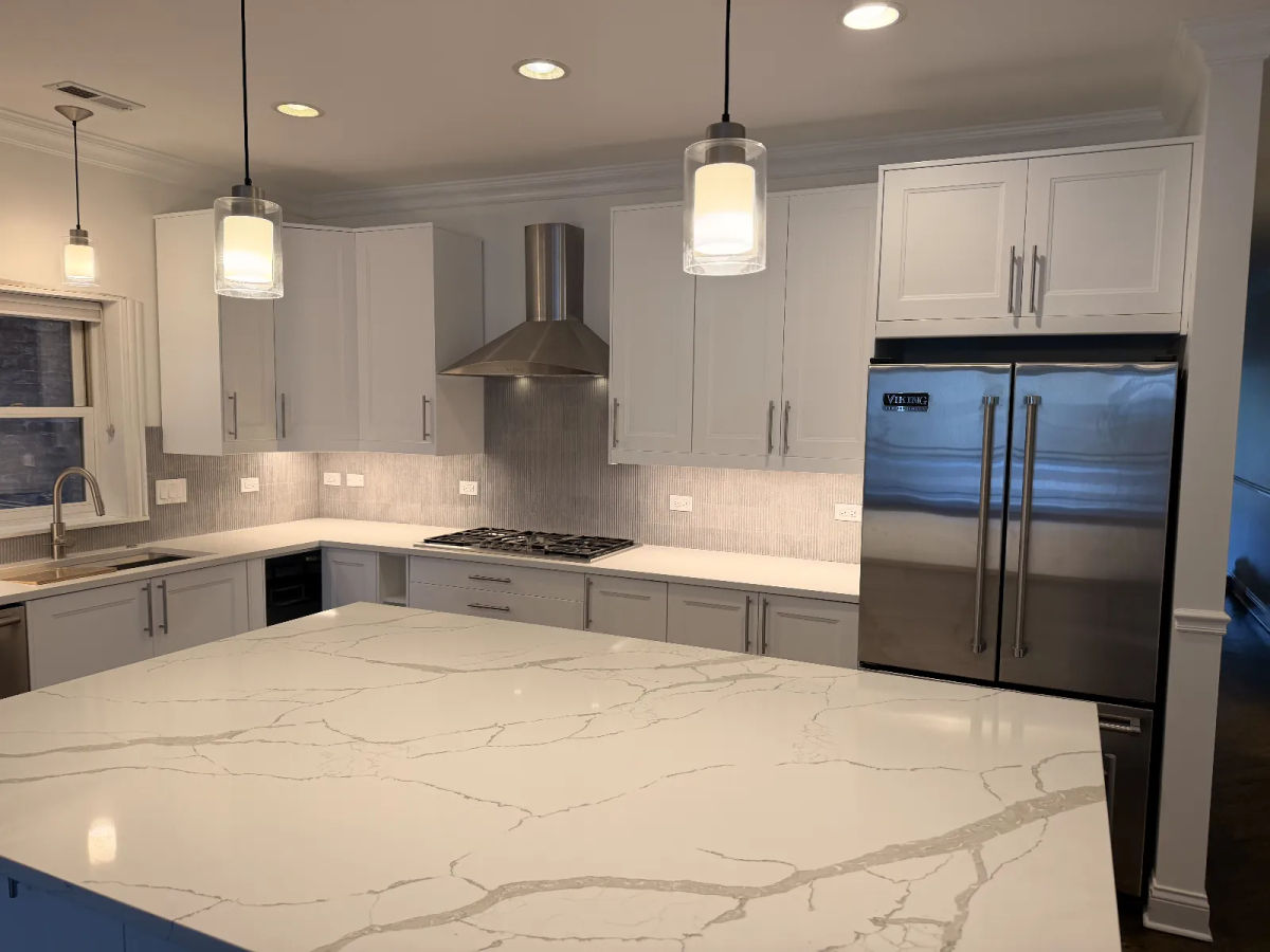 After -- the rebuilt single-level veined quartz island at 456 W Briar Pl, Lakeview