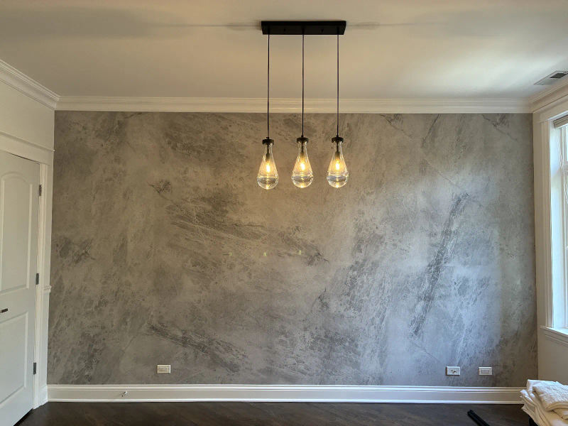 After -- full-height porcelain slab feature wall with teardrop pendants in the dining area at 456 W Briar Pl, Lakeview