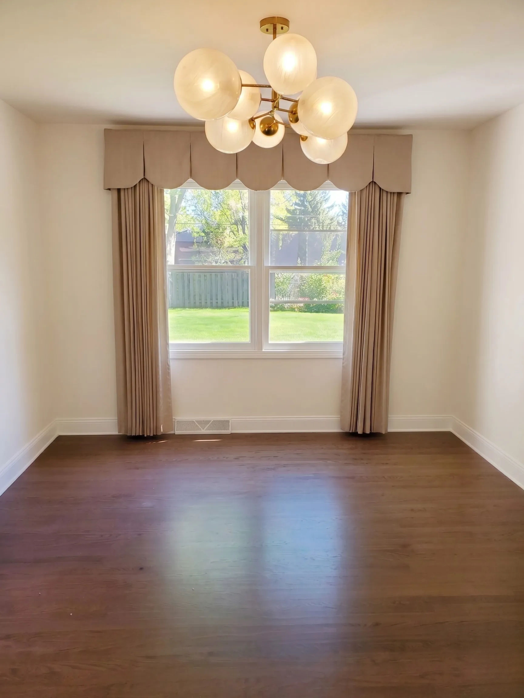 515 W Cedar St Arlington Heights dining room with new modern brass and glass globe chandelier above refinished hardwood floors