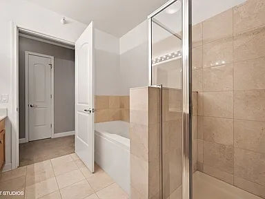 Before -- original framed walk-in shower and tub at 450 E Waterside Dr, Unit 510, The Chandler, prior to the shower rebuild