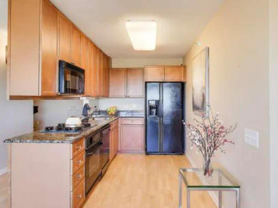 Evanston condo kitchen before remodel 800 Elgin Rd -- dated layout with bulkhead above island