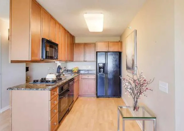 Evanston condo kitchen before remodel 800 Elgin Rd -- dated layout with awkward bulkhead above island