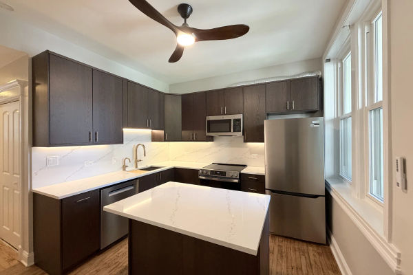 Chicago condo kitchen renovation with waterfall island and full-height windows -- Sheffield Ave, Lakeview