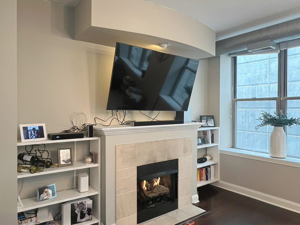 West Loop condo living room before remodel outdated shelving fireplace