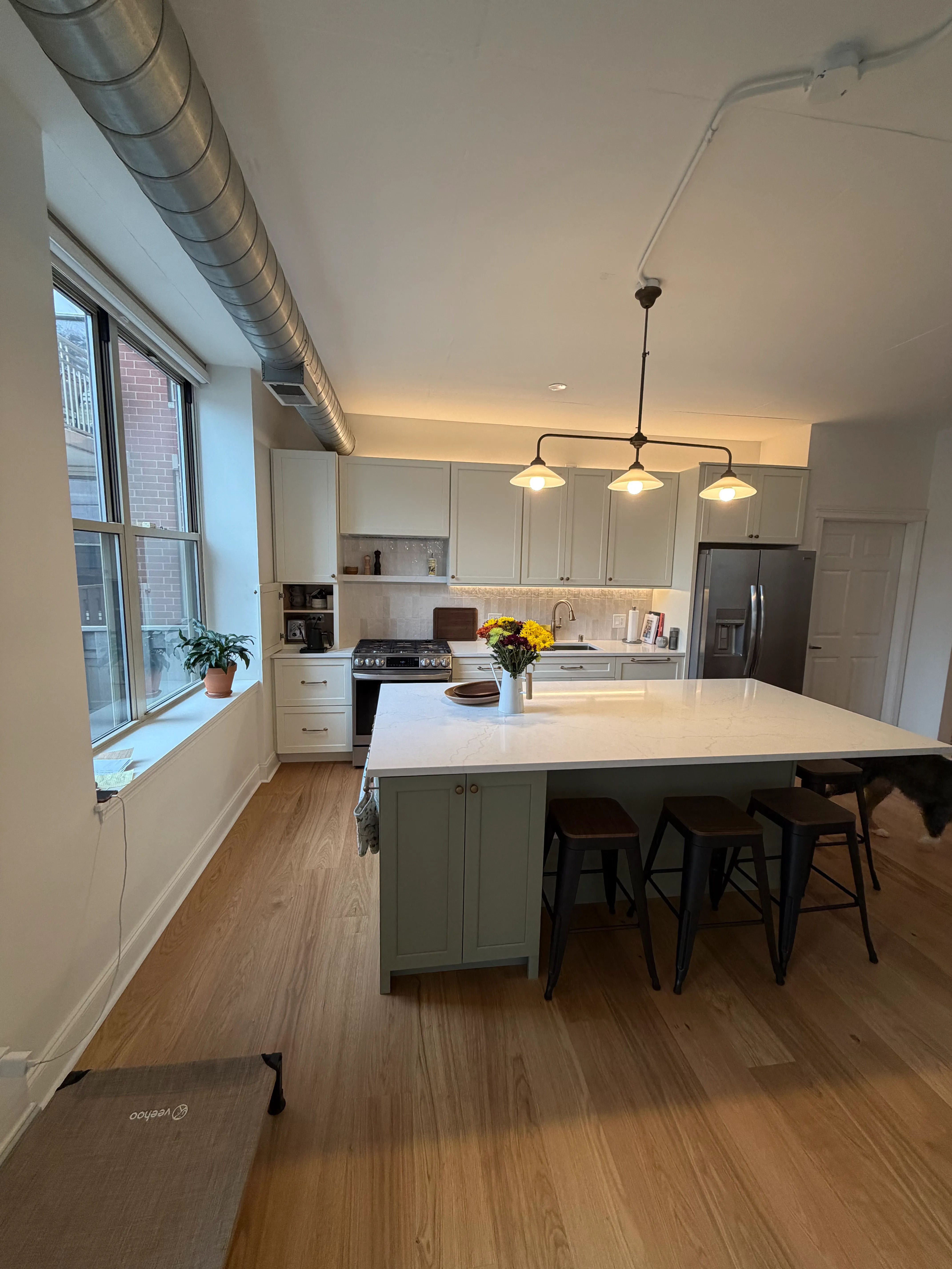 Chicago kitchen and bathroom combo renovation by Assembly Squad showing modern kitchen with quartz countertops and renovated bathroom