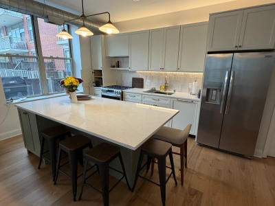 MSI quartz countertops West Loop condo -- floor to ceiling backsplash white gray palette
