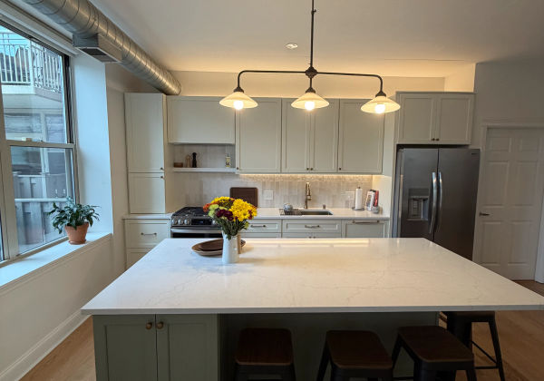 West Loop condo remodeling -- complete unit renovation with two-tone cabinets and walnut flooring