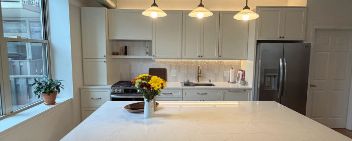1001 W Madison St West Loop condo after remodel -- two-tone custom cabinets and MSI quartz