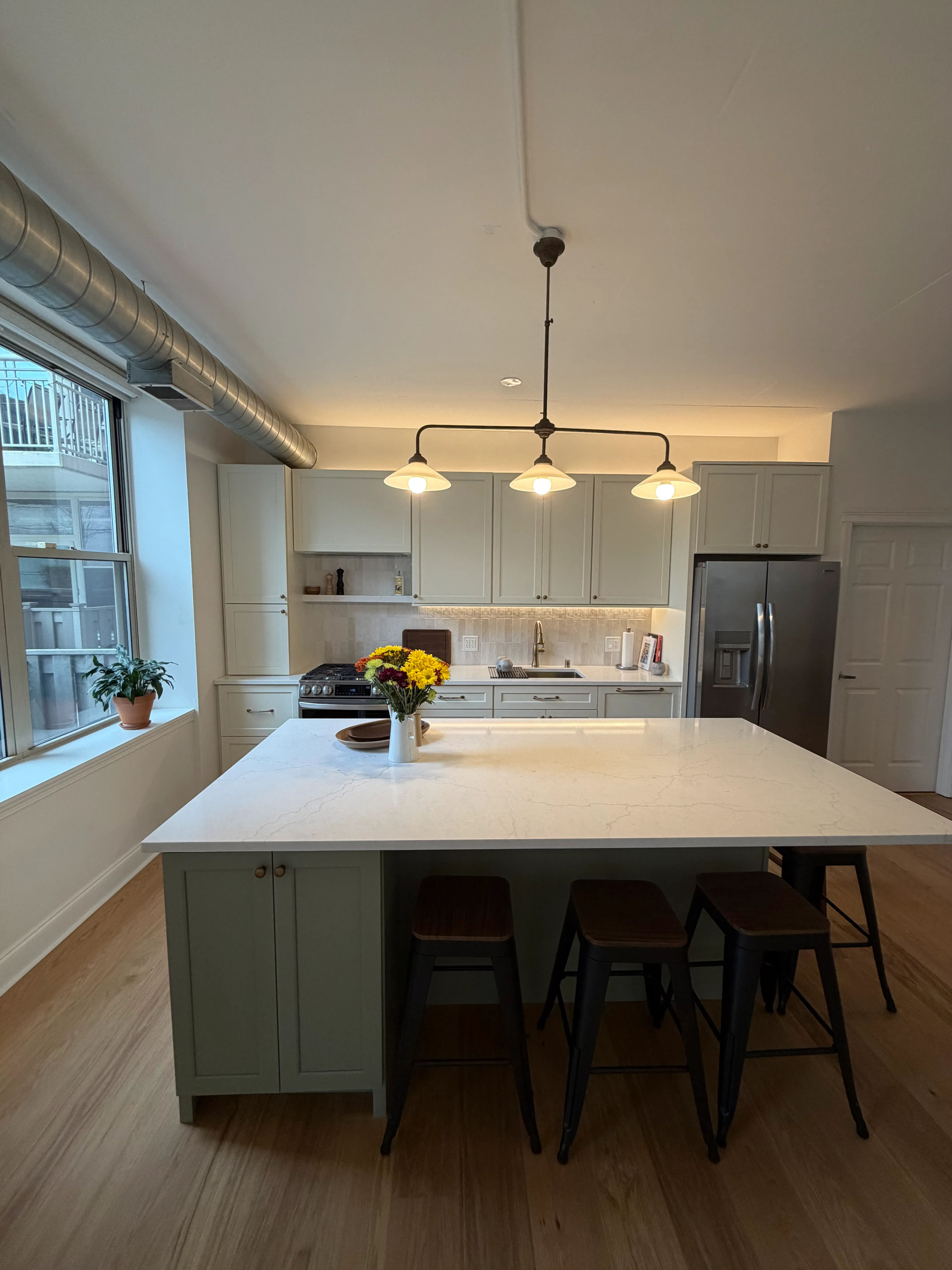 West Loop condo kitchen remodel with custom two-tone cabinets and MSI quartz countertops at 1001 W Madison St