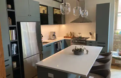 Uptown loft kitchen renovation at 3900 N Claremont with European-style light green custom cabinetry