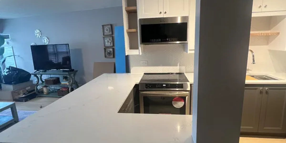 Lincoln Park kitchen with open concept design featuring custom white cabinets and quartz countertops