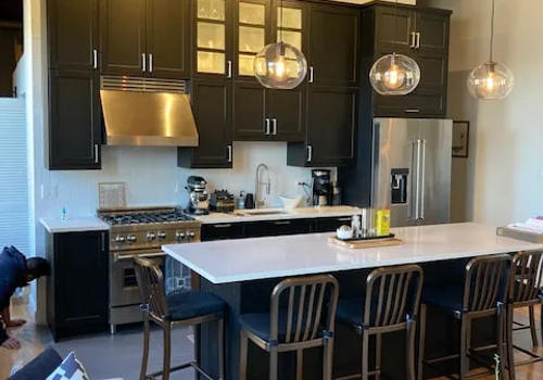 West Loop loft black IKEA kitchen after renovation -- under $28K bold modern Chicago