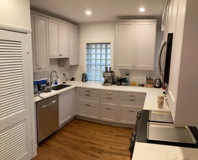 Andersonville kitchen renovation completed January 2024 -- N Magnolia Ave 60640 vintage Chicago home with white cabinetry, white quartz countertops, and reclaimed square footage where the original unused chimney structure was removed during demolition