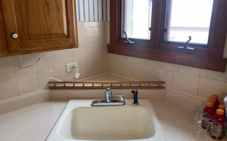 Demo phase: 4 subfloor layers exposed -- North Park bungalow kitchen gut renovation Chicago 60630