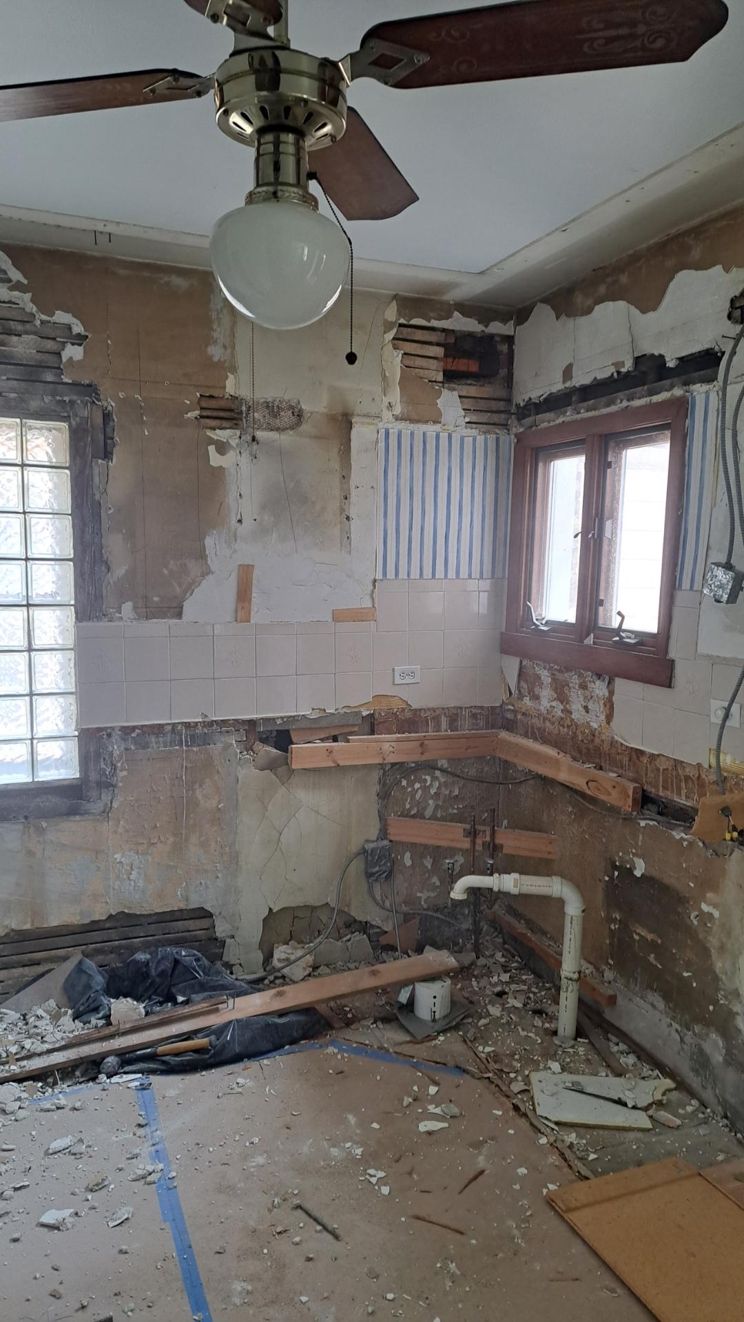 Andersonville vintage kitchen corner showing vent stack discovery during demolition -- N Magnolia Ave concealed-condition documentation