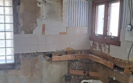 Before: Original North Park bungalow kitchen corner -- dated layout needing gut renovation