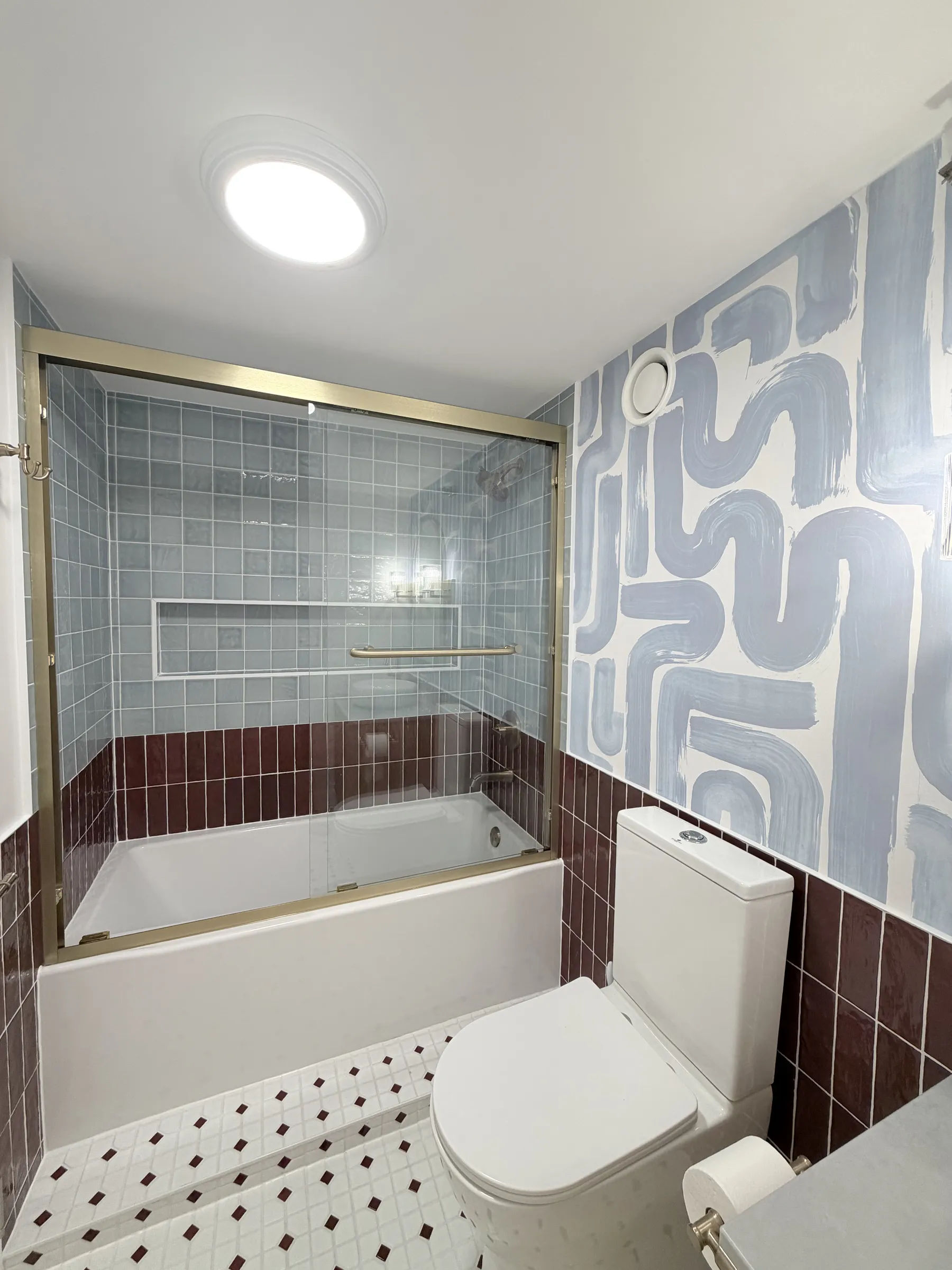Completed bathroom remodel at 124 W Polk, Unit 707, The Lex, Printers Row South Loop Chicago -- Sky Blue Zellige tub/shower with brushed-gold sliding glass door, Bordeaux Zellige wainscot, hex mosaic floor, by Assembly Squad