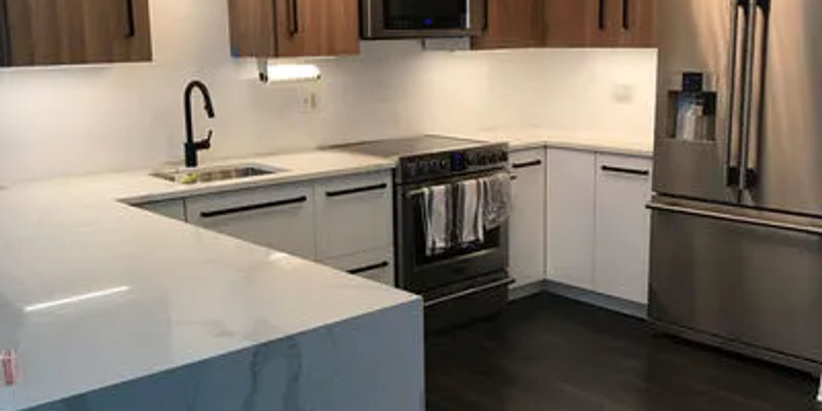 Lakeview kitchen with two-tone cabinets featuring white upper and dark lower cabinetry with stone countertops