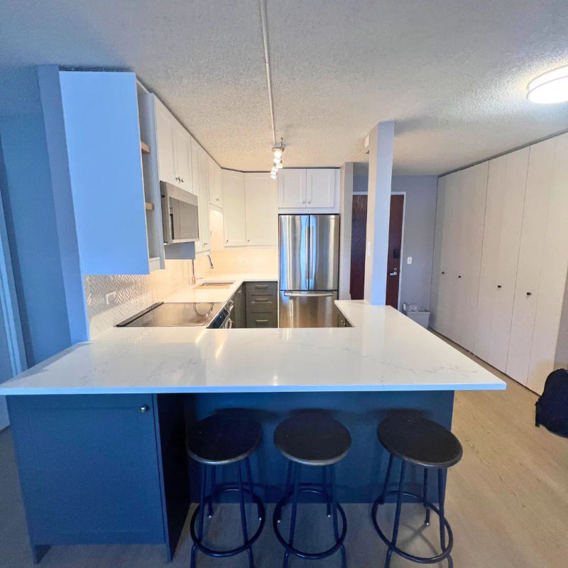 After -- the wall replaced by a white quartz peninsula opening the kitchen to the living space