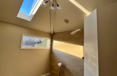 Spacious modern bathroom renovation in Bucktown with custom tile work and walk-in shower