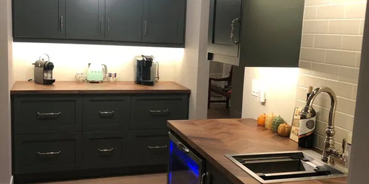 Lincoln Park luxury kitchen -- waterfall quartz island two-tone cabinets $125K renovation