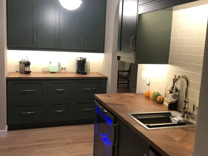 Lincoln Park condo kitchen remodel by Assembly Squad - waterfall quartz island with two-tone cabinets