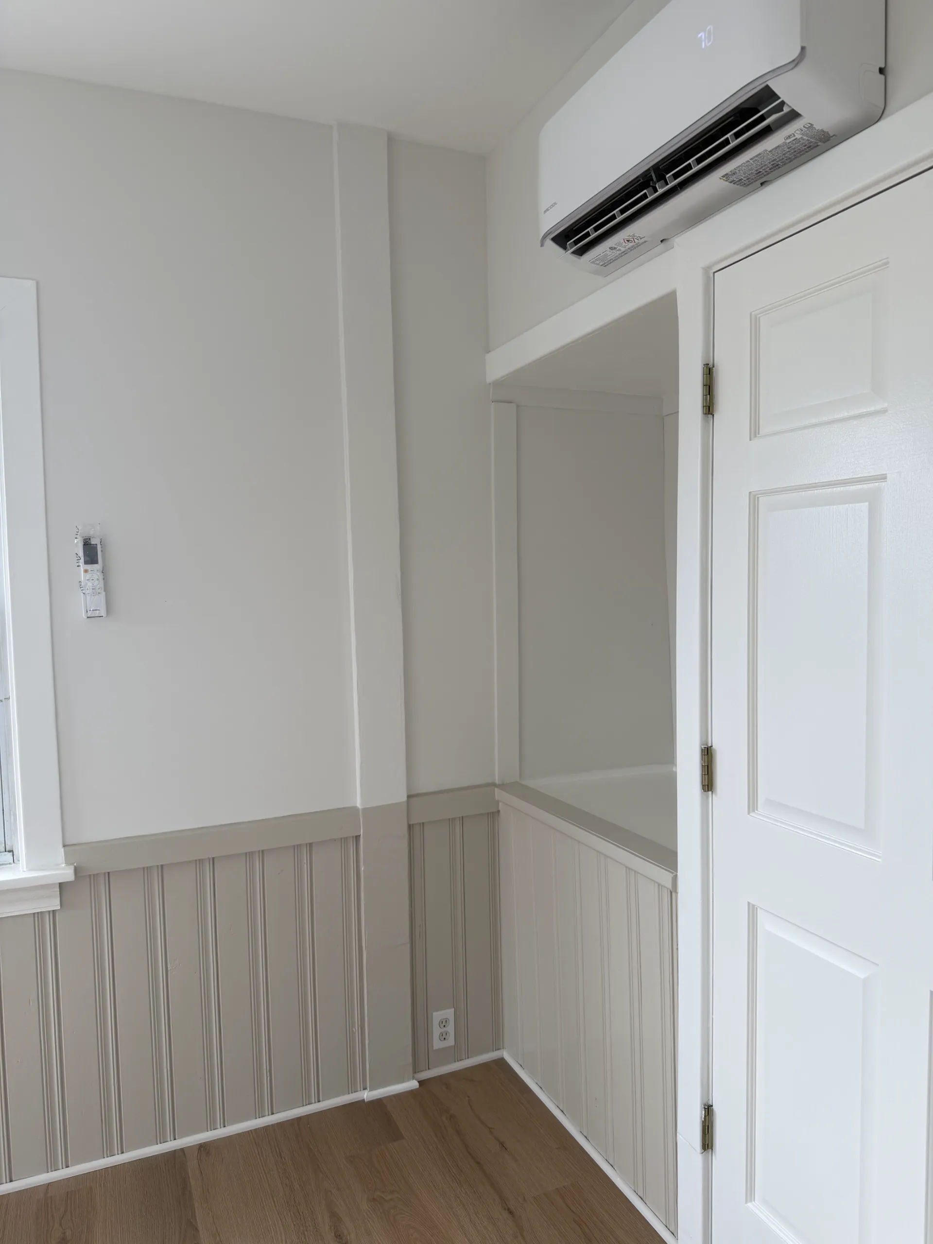 After photo of ductless mini-split head installed above finished closet buildout with beadboard trim in Logan Square Chicago renovation by Assembly Squad