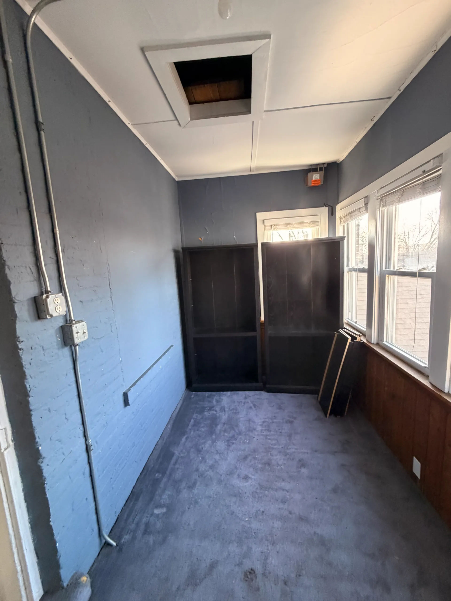 Before photo of original closet area with dated finishes in Chicago three-flat prior to Assembly Squad mini-split and buildout