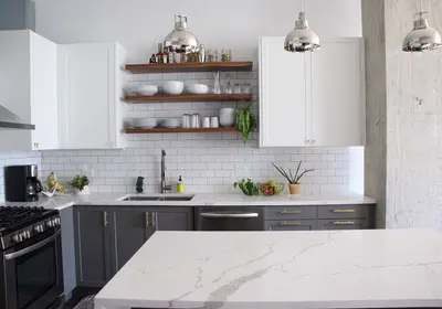 West Loop condo kitchen renovation with two-tone cabinets, floating shelves, and enhanced storage solutions
