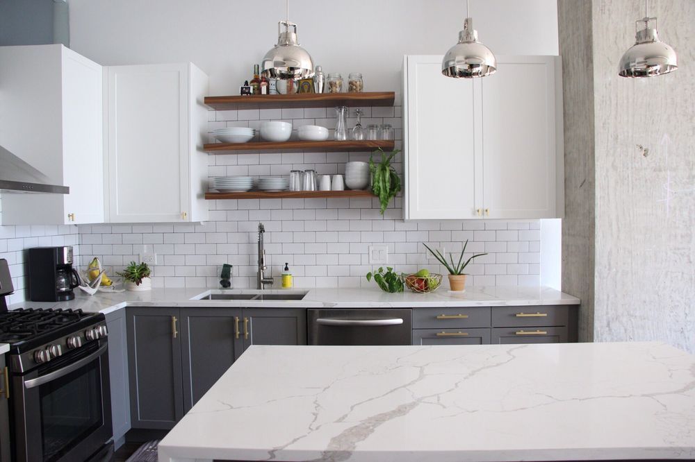 West Loop condo kitchen with two-tone cabinets and floating shelves