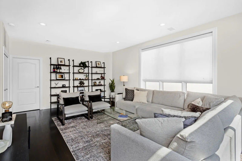 Before -- the top-floor family room wall with ladder shelving where the dry bar was built