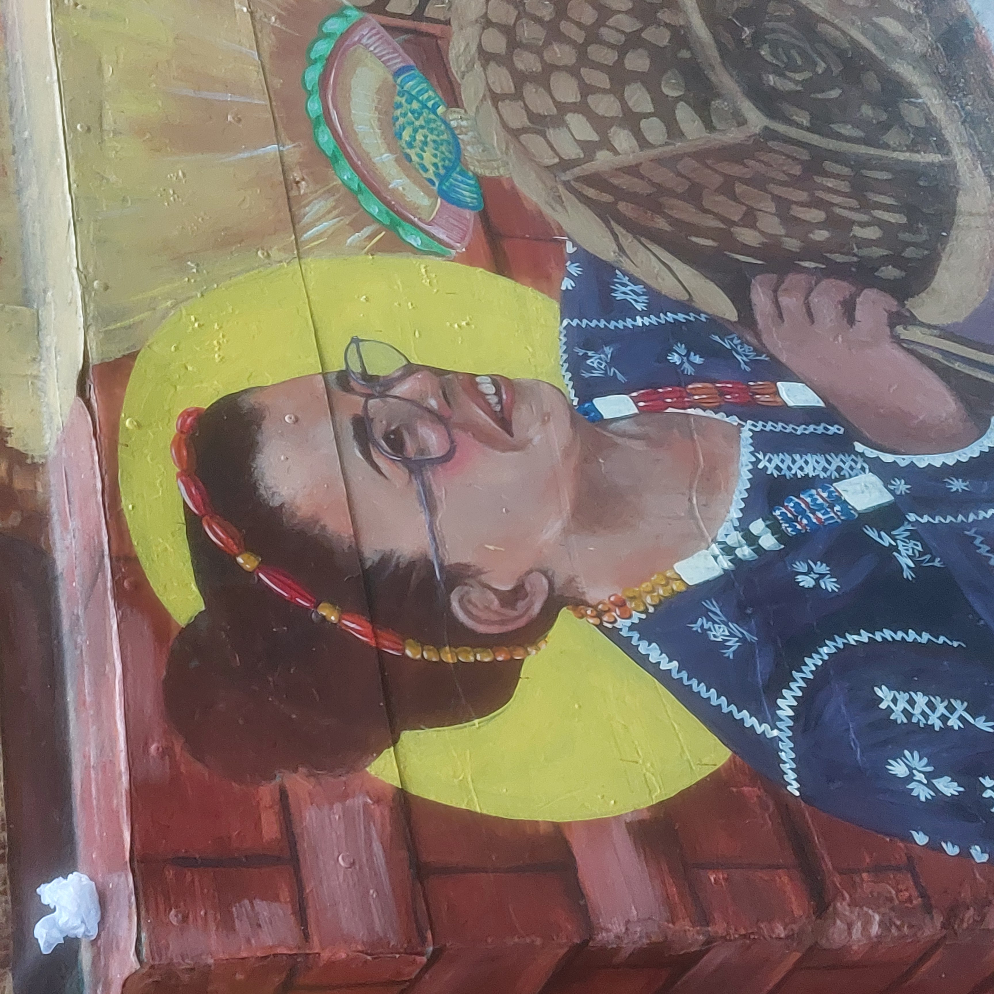 A mural of a woman holding a basket.