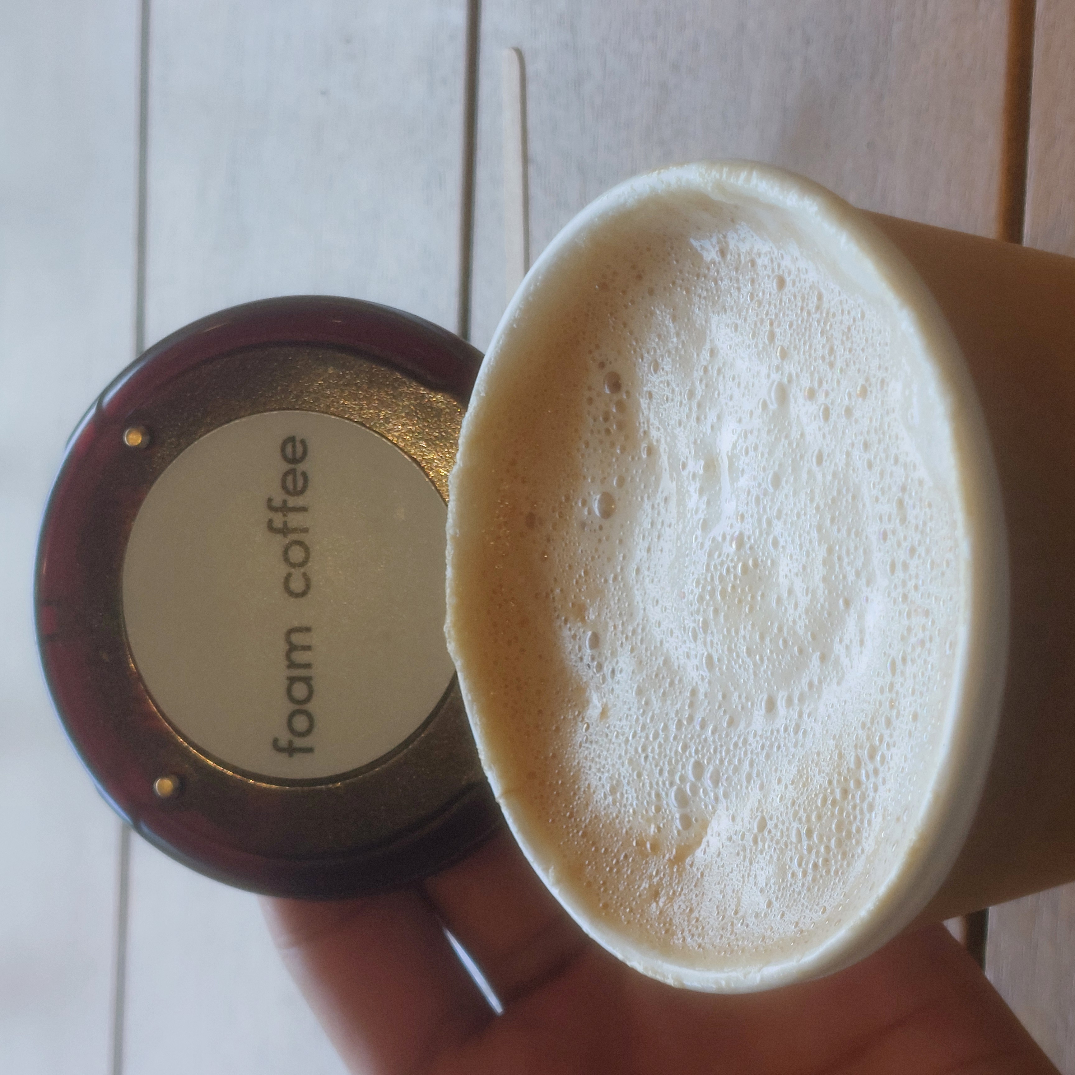 A cup of foamed coffee and a beeper from the coffee shop Foam Coffee.