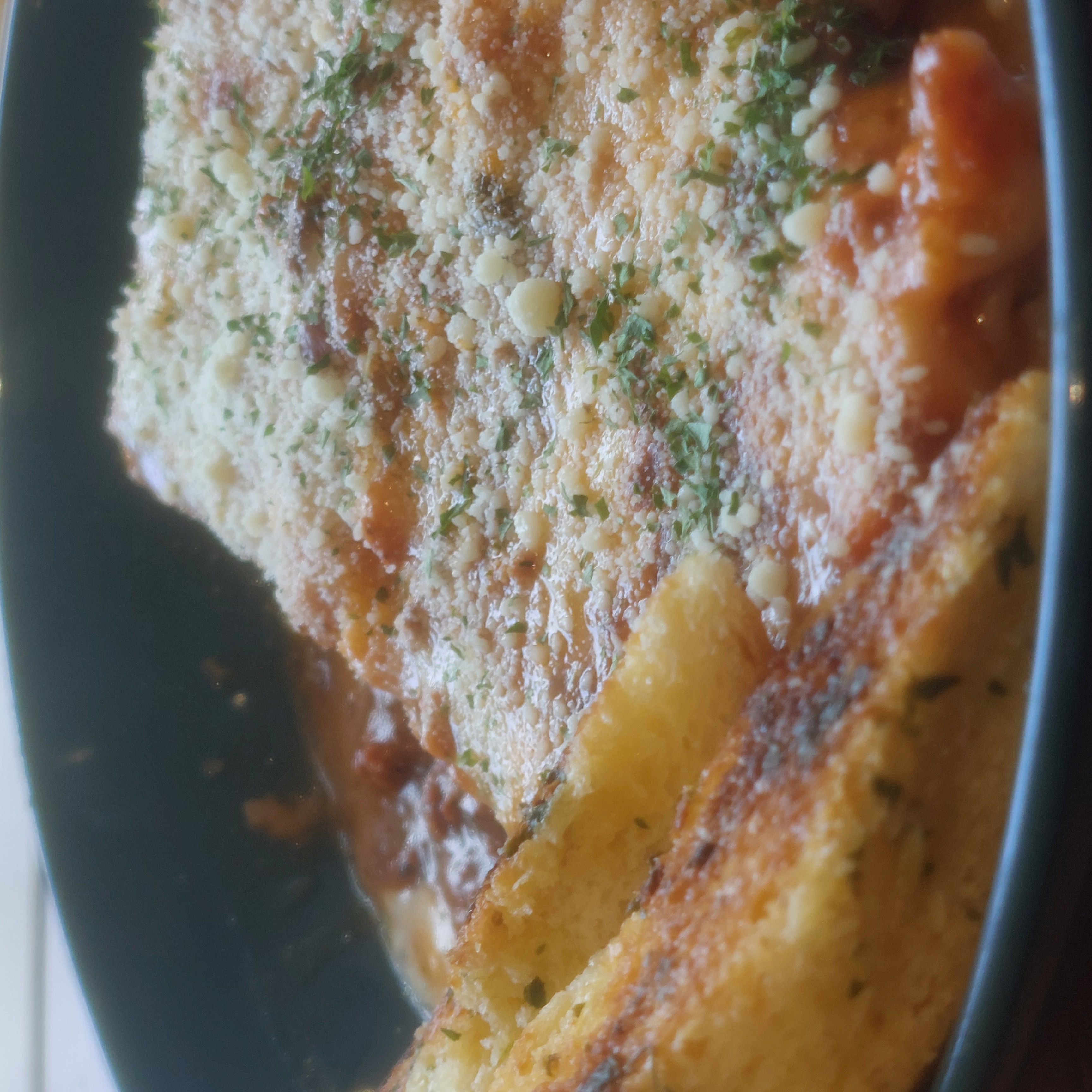 Toasted bread on a beef lasagna