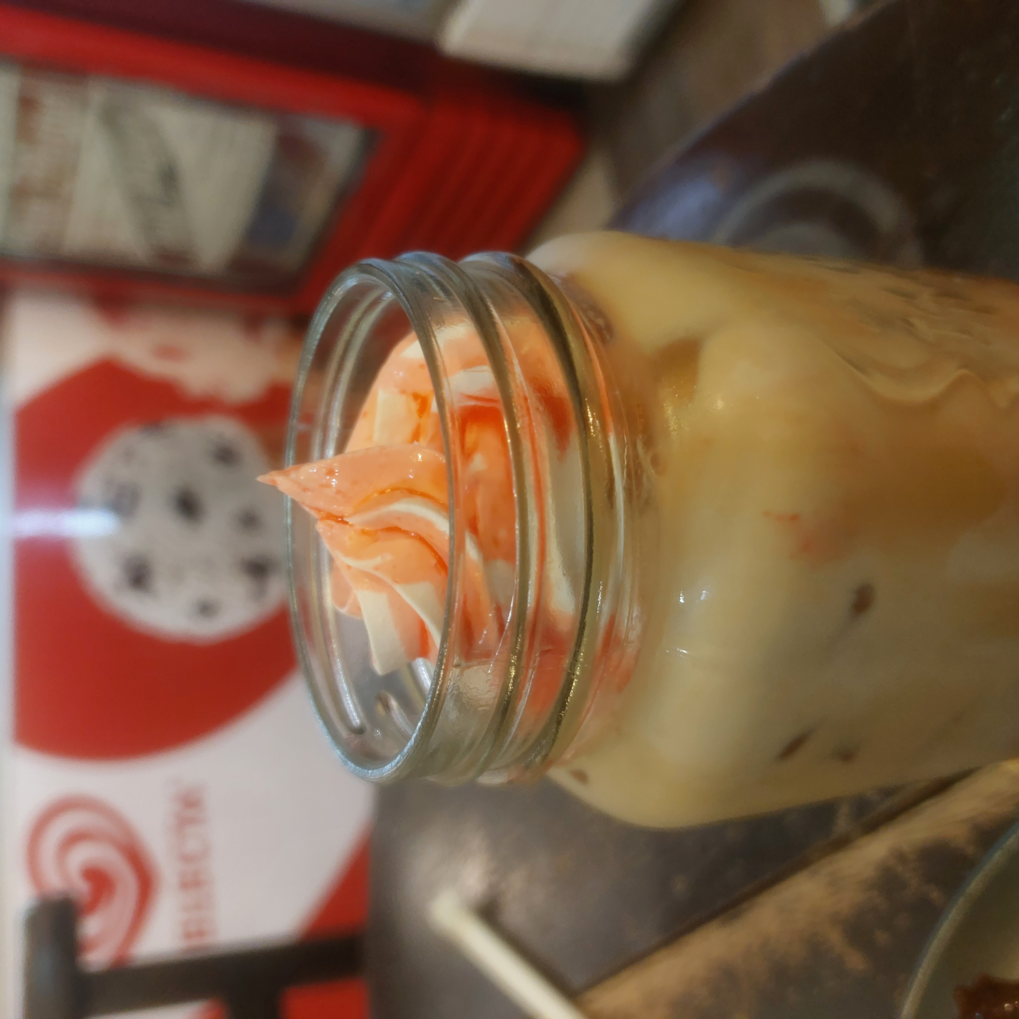 Coffee topped with vanilla and strawberry ice cream.