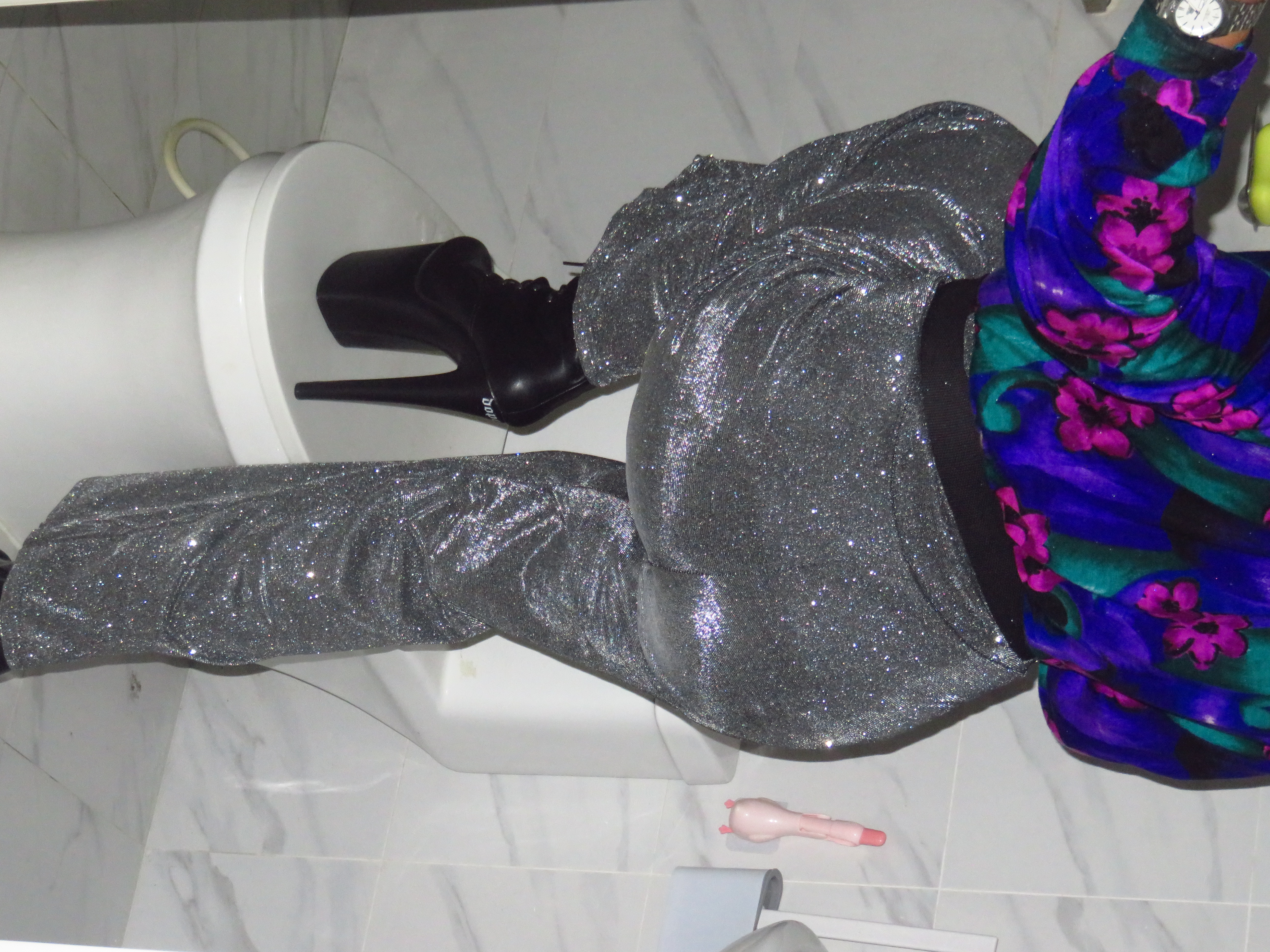 Nico stepping on a covered toilet bowl with his 8-inch heels.