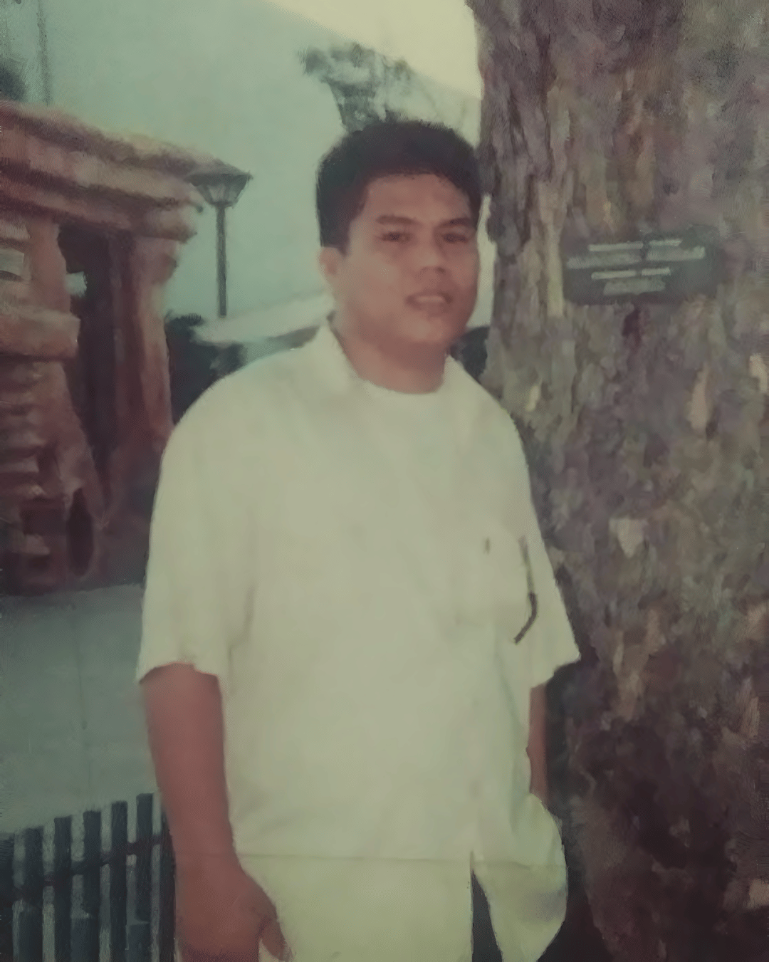 Old picture of a Filipino man in a white button-up shirt.